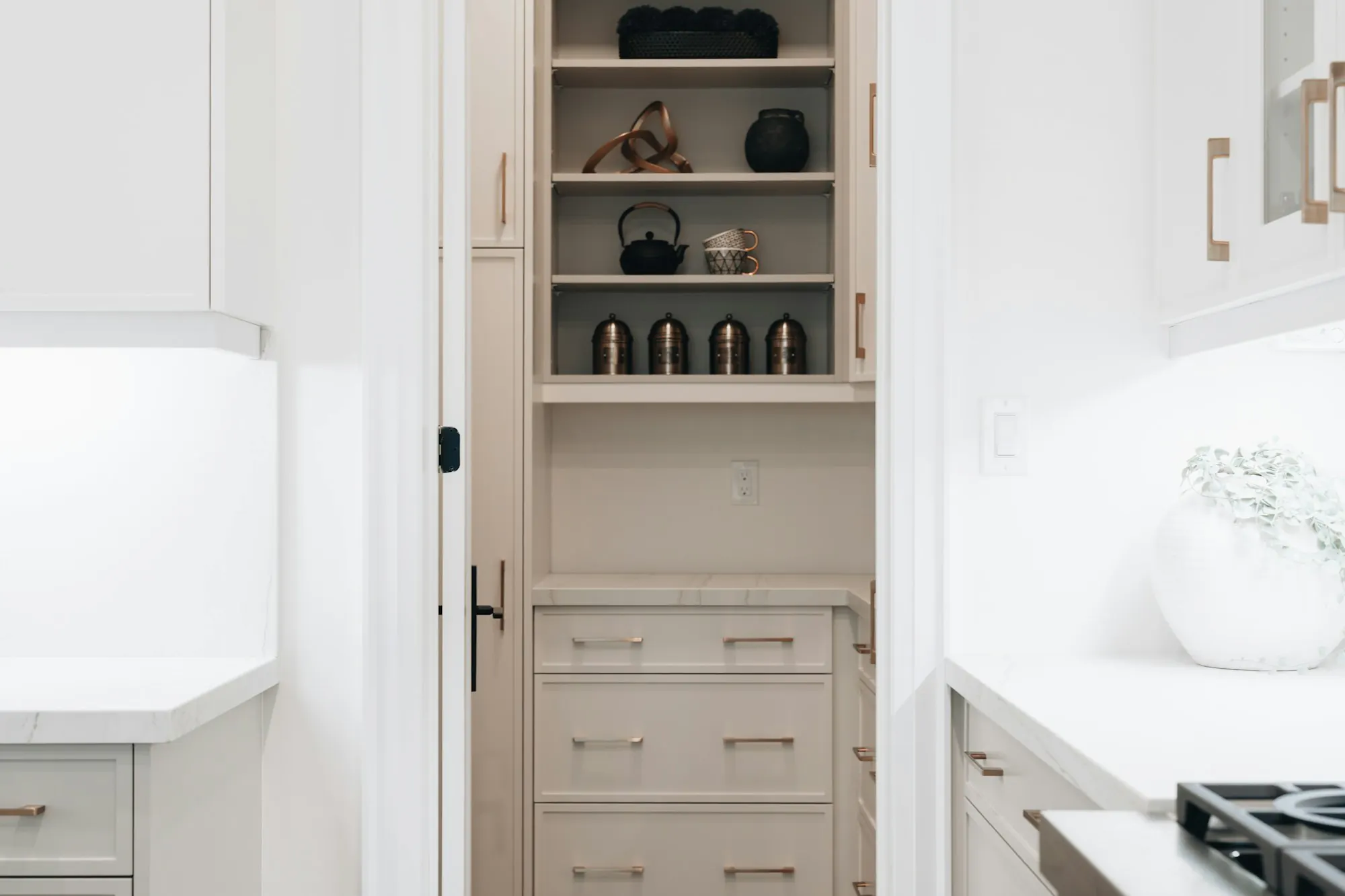 Tidy white pantry with open shelves and drawers