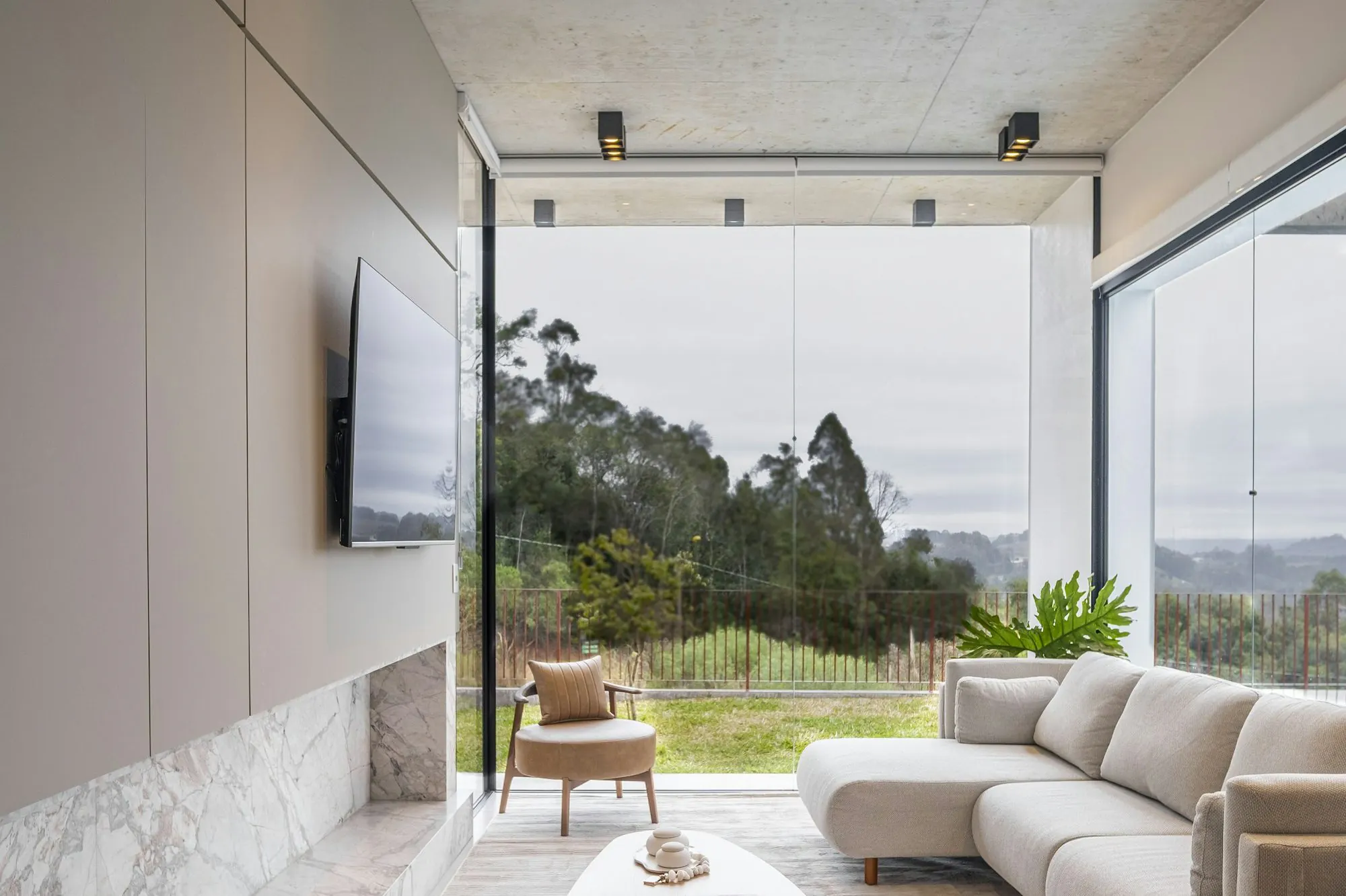 Lodge living room with sunrise through tall windows