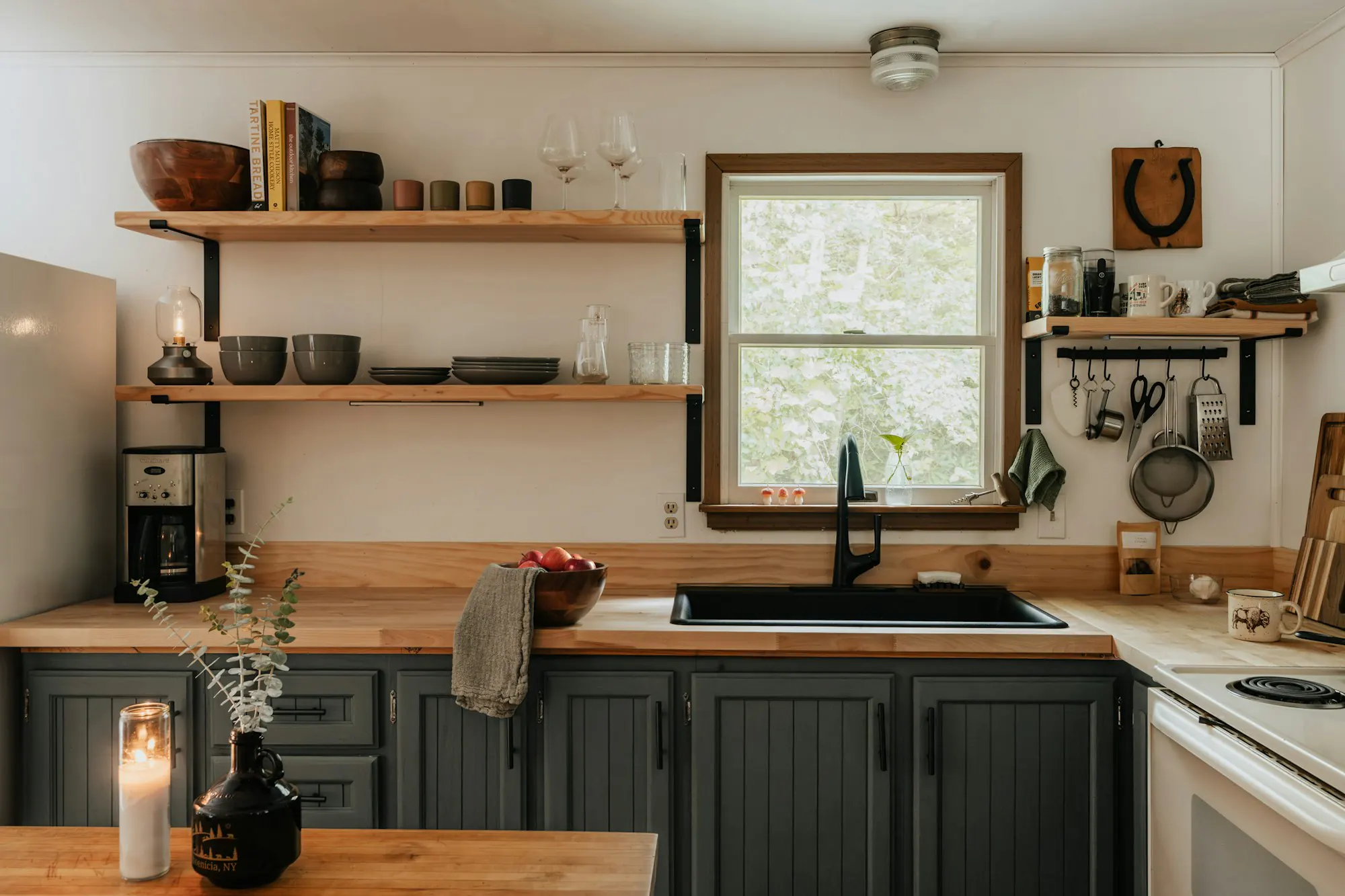 Cottage kitchen with wooden cabinets and open shelves